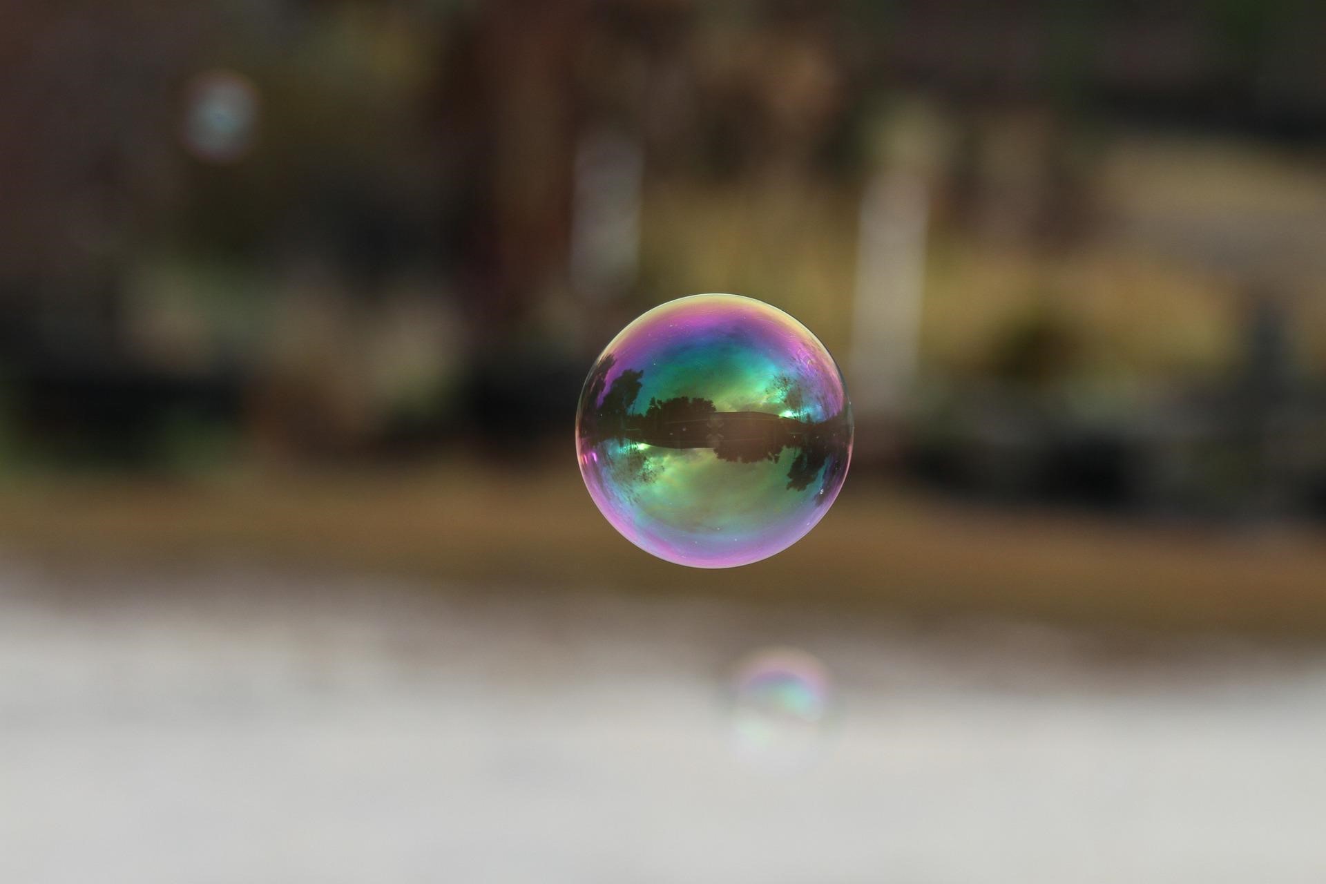 photo of a bubble floating in front of a blurred background