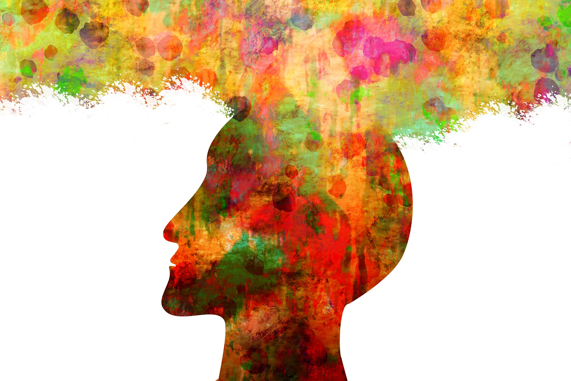 colorful silhouette of human head with colors exploding from top
