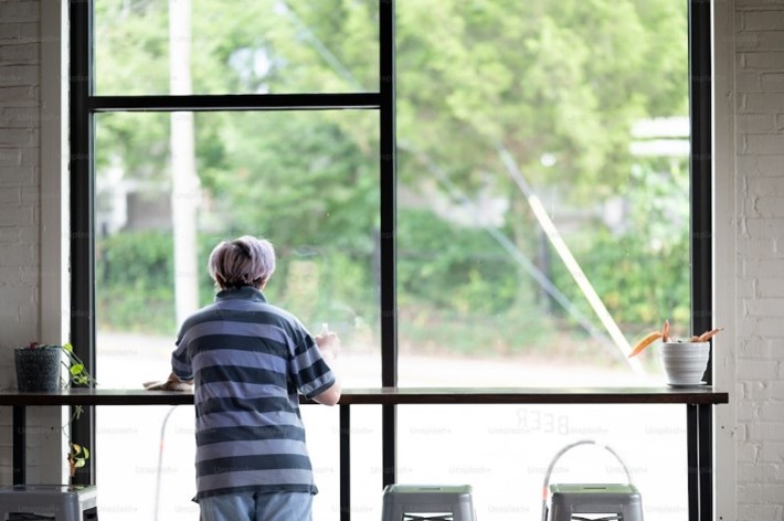 Person looking out a window.